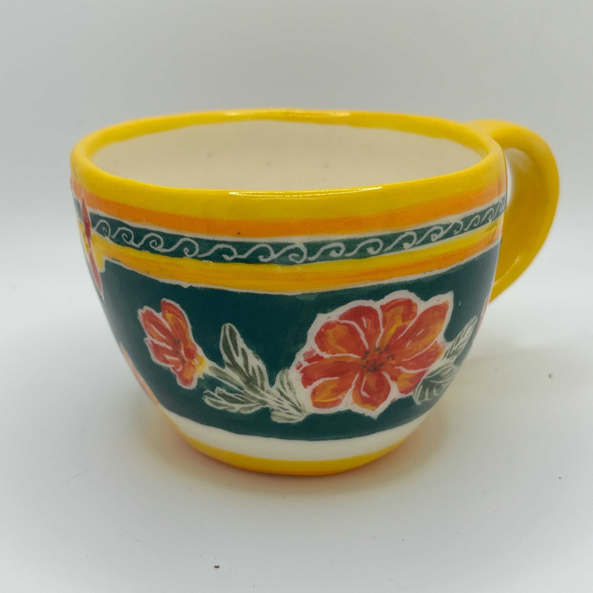 Flowers on green espresso cup